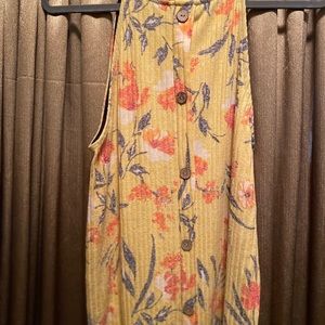 Sleeveless top and buttons down the back.